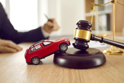 car accident lawyer's desk with gavel and car