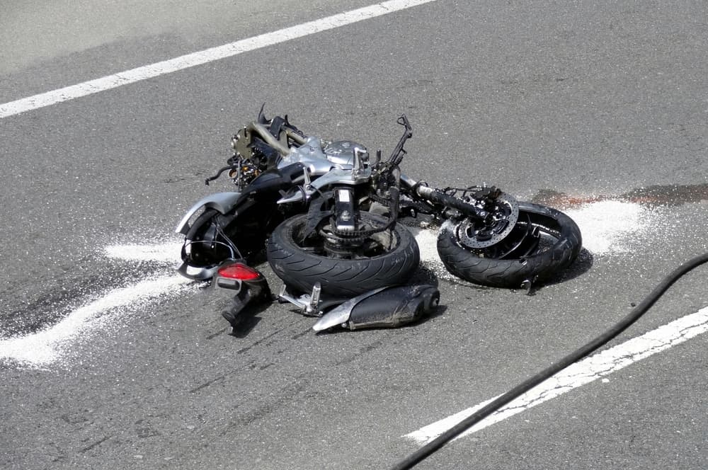 A motorcyclist tragically loses their life in a fatal head-on collision with a car after a risky overtaking maneuver at high speed.