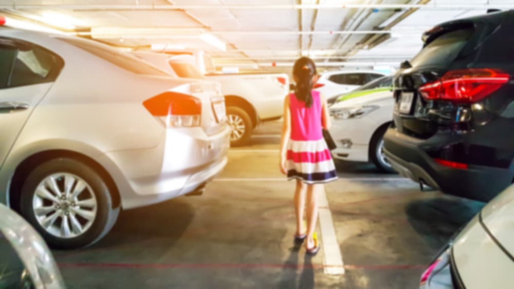 Blurred images of small children walking in the parking lot, is very dangerous