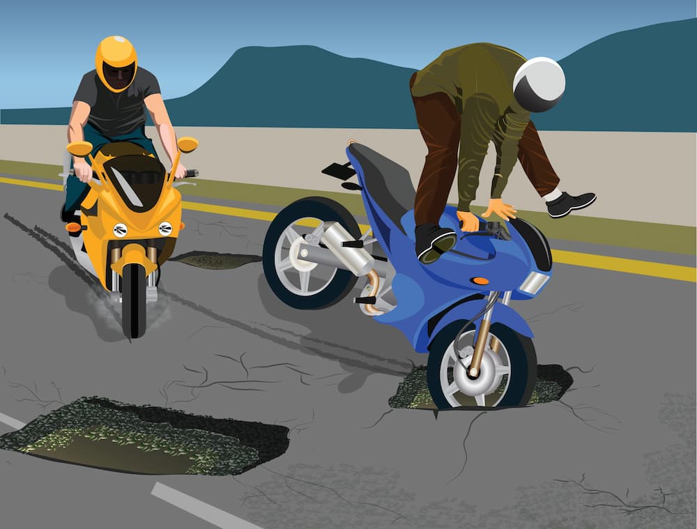 bikers facing potholes and cracks on road